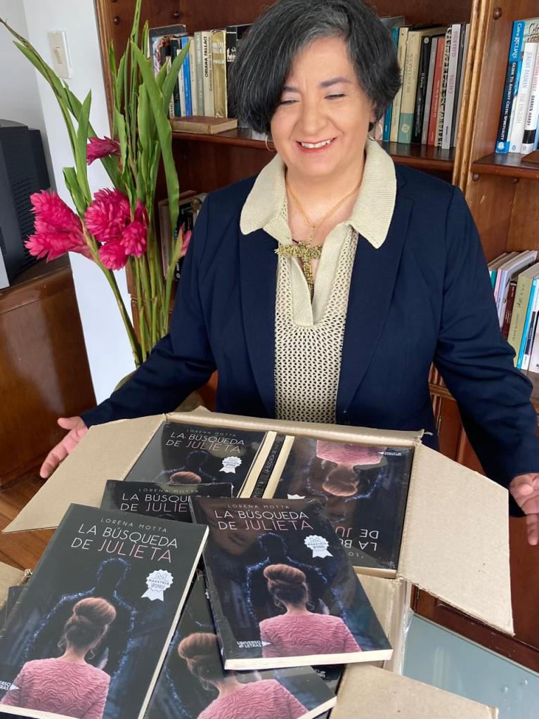 Lorena abriendo la caja, viendo los libros